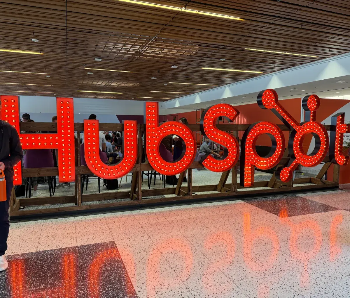 Large illuminated orange HubSpot sign inside the UNBOUND conference center